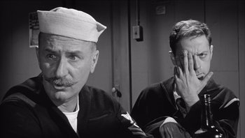 Movie still from “The Americanization of Emily” (1964), directed by Arthur Hiller – Two men sitting next to each other in a room; Close Up shot, Over the shoulder angle