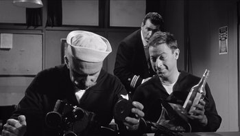 Movie still from “The Americanization of Emily” (1964), directed by Arthur Hiller – A group of men sitting next to each other in a room; Medium shot, High angle