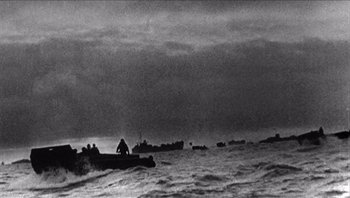 Movie still from “The Americanization of Emily” (1964), directed by Arthur Hiller – A black and white photo of a group of boats in the ocean; Extreme Wide shot, Low angle