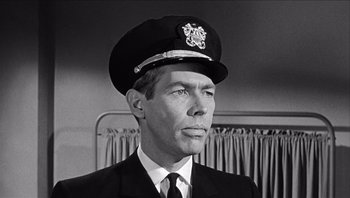 Movie still from “The Americanization of Emily” (1964), directed by Arthur Hiller – Black and white photograph of a man in a uniform; Close Up shot, Low angle