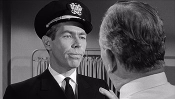 Movie still from “The Americanization of Emily” (1964), directed by Arthur Hiller – An old photo of a man in a uniform talking to another man; Close Up shot, Over the shoulder angle