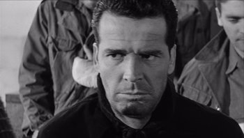 Movie still from “The Americanization of Emily” (1964), directed by Arthur Hiller – Black and white photograph of a man in a shirt and tie; Close Up shot, Low angle