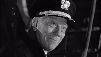 Movie still from “The Americanization of Emily” (1964), directed by Arthur Hiller – An old photo of a man in a uniform smiling for the camera; Close Up shot, Low angle