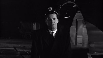 Movie still from “The Americanization of Emily” (1964), directed by Arthur Hiller – A black and white photo of a man in a suit and tie; Close Up shot, Low angle