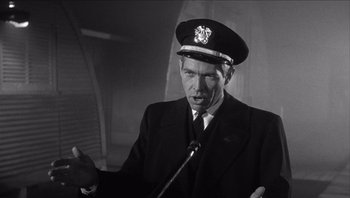Movie still from “The Americanization of Emily” (1964), directed by Arthur Hiller – A man in a suit and a hat; Close Up shot, Low angle