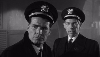 Movie still from “The Americanization of Emily” (1964), directed by Arthur Hiller – A black and white photo of two men in uniform; Close Up shot, Low angle
