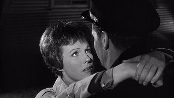 Movie still from “The Americanization of Emily” (1964), directed by Arthur Hiller – An old photo of a man and a woman hugging; Close Up shot, Over the shoulder angle
