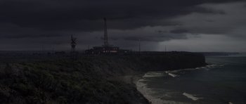 Movie still from “The Andromeda Strain” (1971), directed by Robert Wise – A view of the ocean from a cliff at night time; Extreme Wide shot, High angle