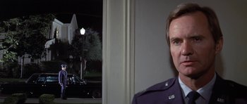 Movie still from “The Andromeda Strain” (1971), directed by Robert Wise – A man in a uniform standing next to a lamp post; Close Up shot, Low angle