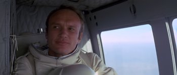 Movie still from “The Andromeda Strain” (1971), directed by Robert Wise – A man sitting in a helicopter looking at the camera; Close Up shot, Low angle