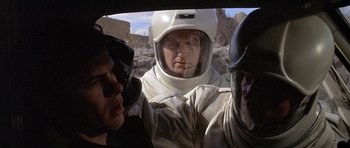Movie still from “The Andromeda Strain” (1971), directed by Robert Wise – A group of people in a car wearing helmets; Close Up shot, Over the shoulder angle