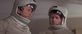 Movie still from “The Andromeda Strain” (1971), directed by Robert Wise – Two men in spacesuits looking at each other; Close Up shot, Low angle