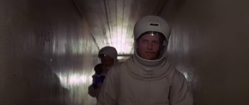 Movie still from “The Andromeda Strain” (1971), directed by Robert Wise – A man in a white suit and a helmet; Medium shot, Low angle