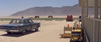 Movie still from “The Andromeda Strain” (1971), directed by Robert Wise – A truck and a tractor in the middle of a field; Extreme Wide shot, High angle