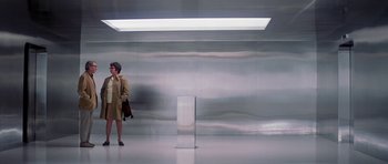 Movie still from “The Andromeda Strain” (1971), directed by Robert Wise – A woman standing in front of a metal wall; Wide shot, Low angle