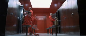 Movie still from “The Andromeda Strain” (1971), directed by Robert Wise – A group of people in red jumpsuits in a room; Wide shot, High angle
