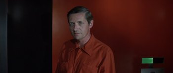 Movie still from “The Andromeda Strain” (1971), directed by Robert Wise – A person wearing a red shirt; Close Up shot, Over the shoulder angle