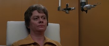 Movie still from “The Andromeda Strain” (1971), directed by Robert Wise – A woman sitting in a chair in front of a mirror; Close Up shot, Low angle