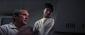 Movie still from “The Andromeda Strain” (1971), directed by Robert Wise – A man and a woman looking at a computer screen; Close Up shot, Low angle