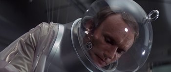 Movie still from “The Andromeda Strain” (1971), directed by Robert Wise – A man in a space suit is looking at the camera; Close Up shot, High angle