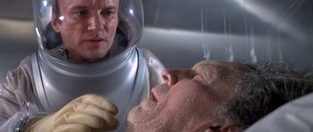 Movie still from “The Andromeda Strain” (1971), directed by Robert Wise – A man in a spacesuit is looking at another man in a spacesuit; Close Up shot, Low angle