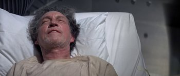 Movie still from “The Andromeda Strain” (1971), directed by Robert Wise – An older man laying in a hospital bed; Close Up shot, High angle