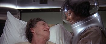 Movie still from “The Andromeda Strain” (1971), directed by Robert Wise – An older man in a hospital bed with a woman; Close Up shot, Over the shoulder angle