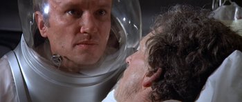 Movie still from “The Andromeda Strain” (1971), directed by Robert Wise – A man looking at himself in the mirror; Close Up shot, Over the shoulder angle