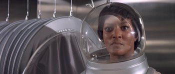 Movie still from “The Andromeda Strain” (1971), directed by Robert Wise – A woman in a space helmet looking into a mirror; Close Up shot, Low angle