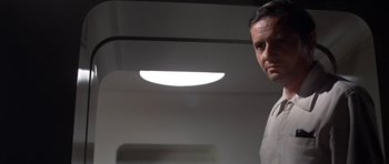 Movie still from “The Andromeda Strain” (1971), directed by Robert Wise – A person standing in a room; Close Up shot, Low angle