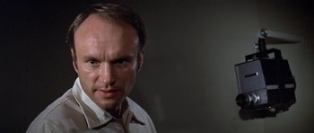 Movie still from “The Andromeda Strain” (1971), directed by Robert Wise – A person wearing a white shirt; Close Up shot, Low angle