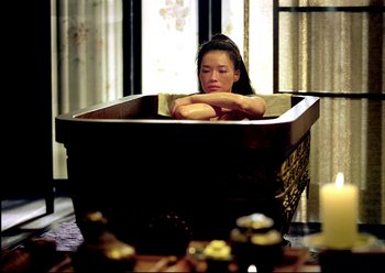 Movie still from “The Assassin” (2015), directed by Hsiao-Hsien Hou – A woman sitting inside of a tub of water; Wide shot, High angle