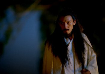 Movie still from “The Assassin” (2015), directed by Hsiao-Hsien Hou – A man with long black hair wearing a white shirt; Medium shot, Over the shoulder angle
