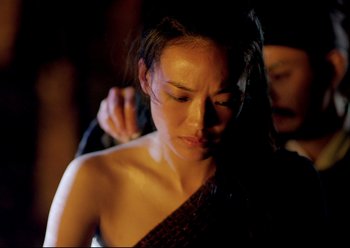 Movie still from “The Assassin” (2015), directed by Hsiao-Hsien Hou – A woman is getting her hair combed by another woman; Close Up shot, Over the shoulder angle
