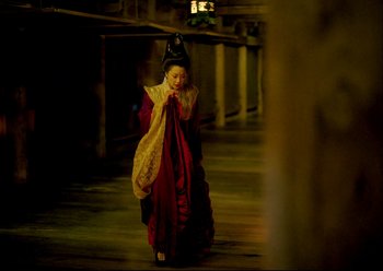 Movie still from “The Assassin” (2015), directed by Hsiao-Hsien Hou – A woman dressed as a geisha walks down the street; Wide shot, High angle