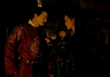 Movie still from “The Assassin” (2015), directed by Hsiao-Hsien Hou – A man and a woman are talking to each other; Medium shot, Over the shoulder angle