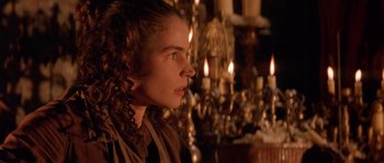 Movie still from “The Baby of Mâcon” (1993), directed by Peter Greenaway – A young woman in a victorian dress looking to her left; Close Up shot, Over the shoulder angle