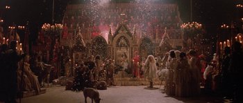 Movie still from “The Baby of Mâcon” (1993), directed by Peter Greenaway – A group of people standing in a room with lights; Extreme Wide shot, High angle