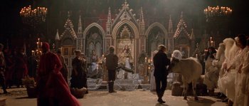 Movie still from “The Baby of Mâcon” (1993), directed by Peter Greenaway – A group of people standing in front of an altar; Wide shot, High angle