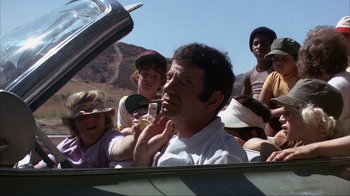 Movie still from “The Bad News Bears” (1976), directed by Michael Ritchie – A group of people sitting in the back of a car; Medium shot, Over the shoulder angle