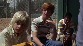 Movie still from “The Bad News Bears” (1976), directed by Michael Ritchie – A group of young people sitting next to each other; Medium shot, Low angle
