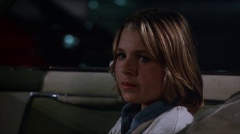 Movie still from “The Bad News Bears” (1976), directed by Michael Ritchie – A woman sitting in the back seat of a car; Close Up shot, Over the shoulder angle