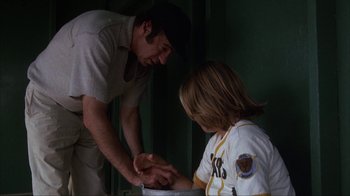 Movie still from “The Bad News Bears” (1976), directed by Michael Ritchie – A man and a boy are playing a game of baseball; Medium shot, Low angle
