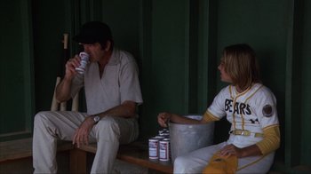 Movie still from “The Bad News Bears” (1976), directed by Michael Ritchie – A man and a woman sitting next to each other; Medium shot, Low angle