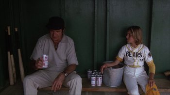 Movie still from “The Bad News Bears” (1976), directed by Michael Ritchie – A man sitting next to a boy holding a can of beer; Medium shot, Over the shoulder angle