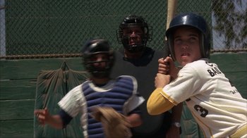 Movie still from “The Bad News Bears” (1976), directed by Michael Ritchie – A group of baseball players standing next to each other on a baseball field; Medium shot, Over the shoulder angle
