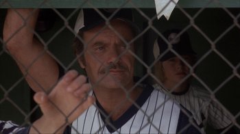 Movie still from “The Bad News Bears” (1976), directed by Michael Ritchie – A baseball player is looking through a chain link fence; Close Up shot, Low angle