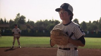 Movie still from “The Bad News Bears” (1976), directed by Michael Ritchie – A baseball player holding a catchers mitt on a baseball field; Medium shot, Low angle