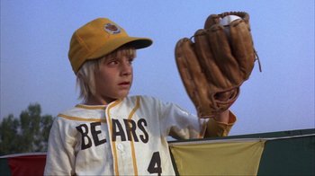 Movie still from “The Bad News Bears” (1976), directed by Michael Ritchie – A young baseball player holding a catchers mitt in his hand; Close Up shot, Low angle
