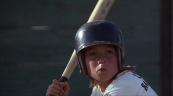 Movie still from “The Bad News Bears” (1976), directed by Michael Ritchie – A young boy holding a baseball bat wearing a helmet; Close Up shot, Low angle